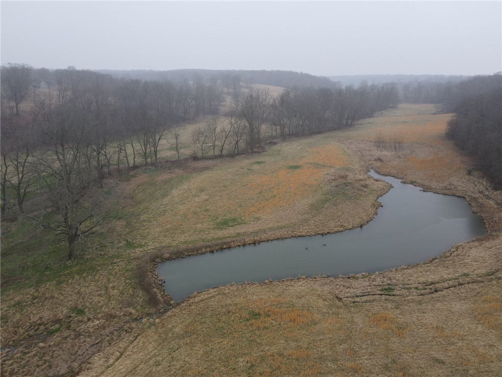 One of the prettiest farms/land you will find in NWA.  Three continuous parcels for a total of 242.33 +/- acres with live water running through it and several ponds just outside of Decatur or 20 mins to Bentonville.  Approximately 128 acres of good pasture and 114 acs of timber and perfect cover for the abundant deer and wildlife.  The home is approximately 2900 sqft and 85% finished in 2016 (as is) but very livable with enormous potential.  Property also includes a barn and old mobile home (also as is).  Great chance to own your own paradise in the heart of NWA but away from the hustle and bustle!