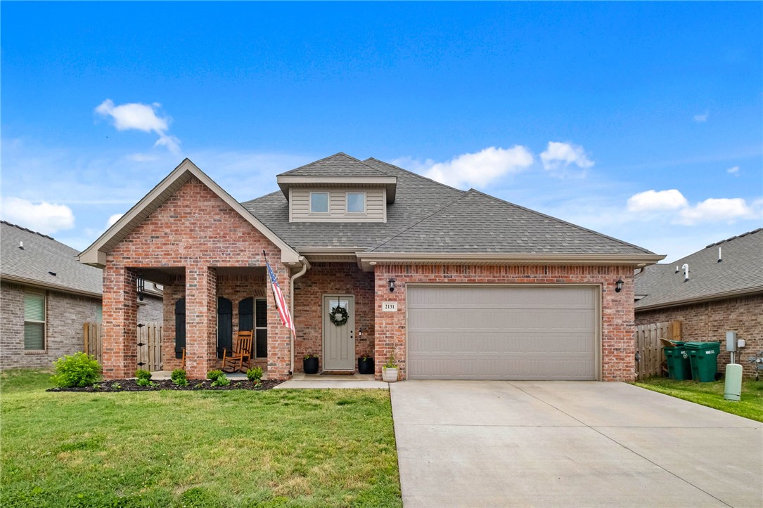 Discover the essence of modern living at 2131 Periwinkle PL in Centerton, Arkansas. Built in 2022, this single-family residence is in great condition, offering an attractive property for discerning homeowners. The heart of this home is its open-plan kitchen, seamlessly flowing into the living room. The kitchen is equipped with matching black appliances and features a convenient peninsula, ideal for casual dining or entertaining. The adjacent living room provides a comfortable gathering space, anchored by a welcoming fireplace. Retreat to one of the three well-appointed bathrooms, each designed for comfort and ease. The primary bathroom offers the luxury of two sinks and a spacious walk-in shower. The home provides three comfortable bedrooms for private relaxation. Beyond the interior, a private yard offers outdoor living space for enjoyment. An attached garage provides convenience, while a dedicated laundry room simplifies daily routines. Enjoy the outdoors from either the inviting patio or the charming porch.