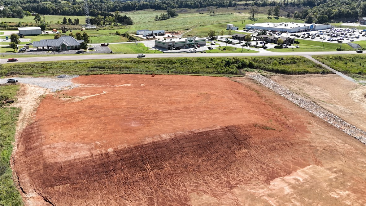 Prime 3 m/l acres corner lot with approximately 375ft of Hwy 412 frontage. As well as 375ft frontage on a County Road. Zoned dual use (DUZ) with city water/sewer, natural gas, electric, and fiber optic available on site. Desirable commercial location with high visibility in a growing area. 11,000 daily traffic count average (2023). Cleared, level with dirt work done. Across from Huntsville Walmart Supercenter and other thriving businesses. Adjoining 10 m/l acres also available. Asking $8.50/ft2 pending a survey. Utility availability is the responsibility of the buyer or buyers agent.