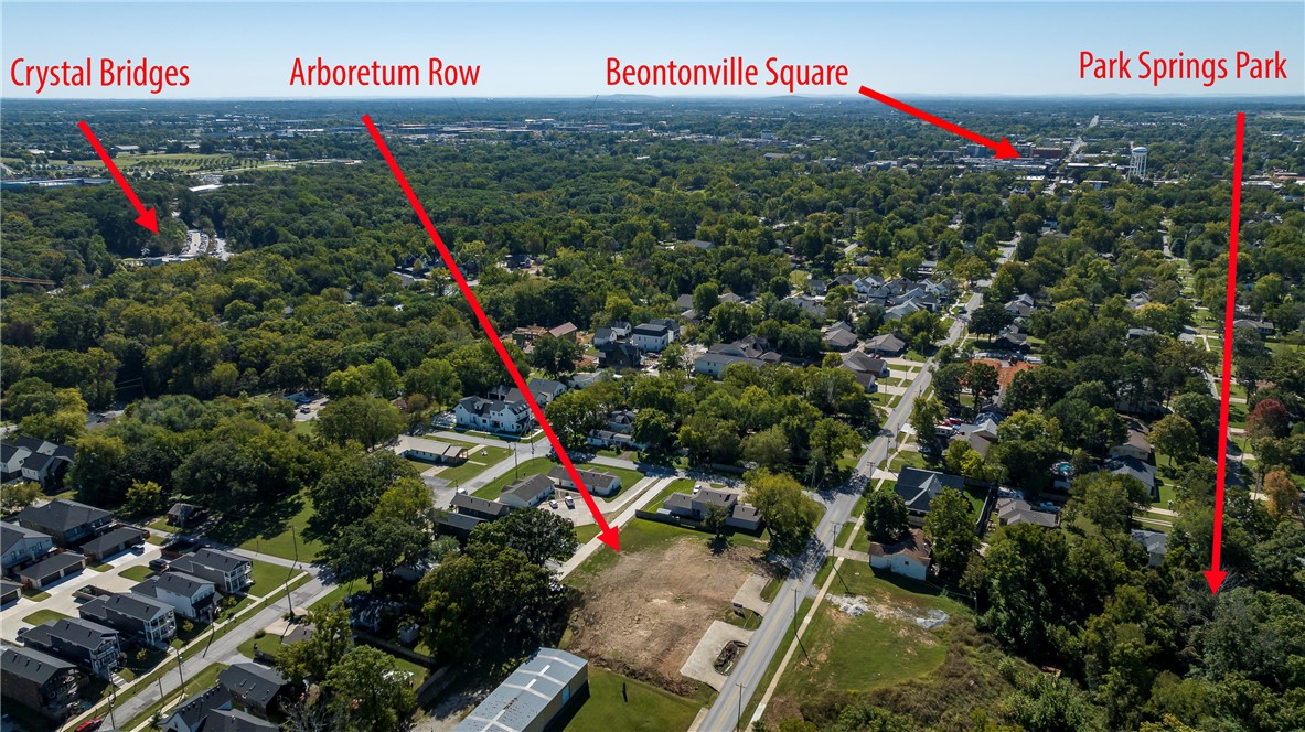 Welcome to the Arboretum Row- LOT 37!  Build your custom Downtown Bentonville cottage with Mark Russell Homes!  North Bentonville’s charming new neighborhood nestled in a coveted area and ideal location anchoring you in a place where convenience, natural beauty, and cultural experiences seamlessly coexist. Just a short walk to Park Springs Park and Briartown Trailhead, you’ll have easy access to a vibrant trail system, recreational areas, and more. Situated just a 4-minute drive from the renowned Crystal Bridges Museum, Arboretum Row offer residents the perfect blend of cultural immersion and tranquil living