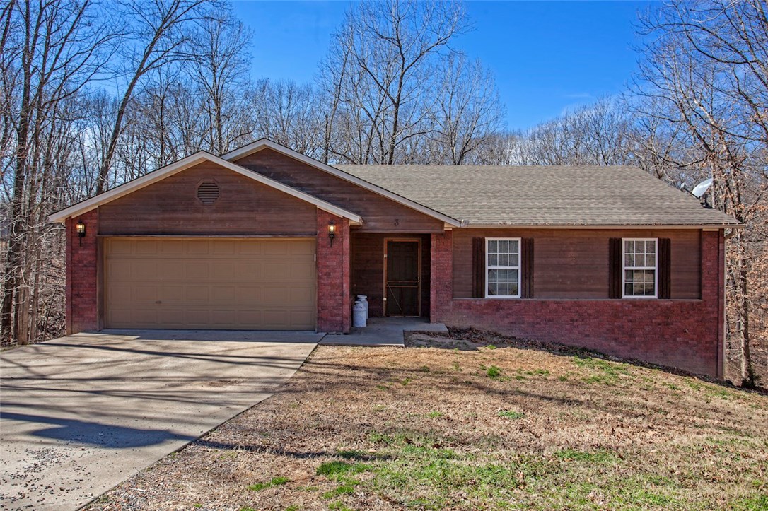 Ten minutes from Bentonville nestled among the trees just off of Oldham & Chelsea Rd., is a charming four-bedroom, two bath home with a two-car garage. Enjoy your morning coffee on one of two decks that over look a semi private back yard, master bedroom and two other bedrooms are upstairs, 1-bedroom downstairs with a theater/gaming area, and walk out basement, Sony projector conveys with a reasonable offer.  The price of this home cannot be beat at just $70.16 a sq. ft.