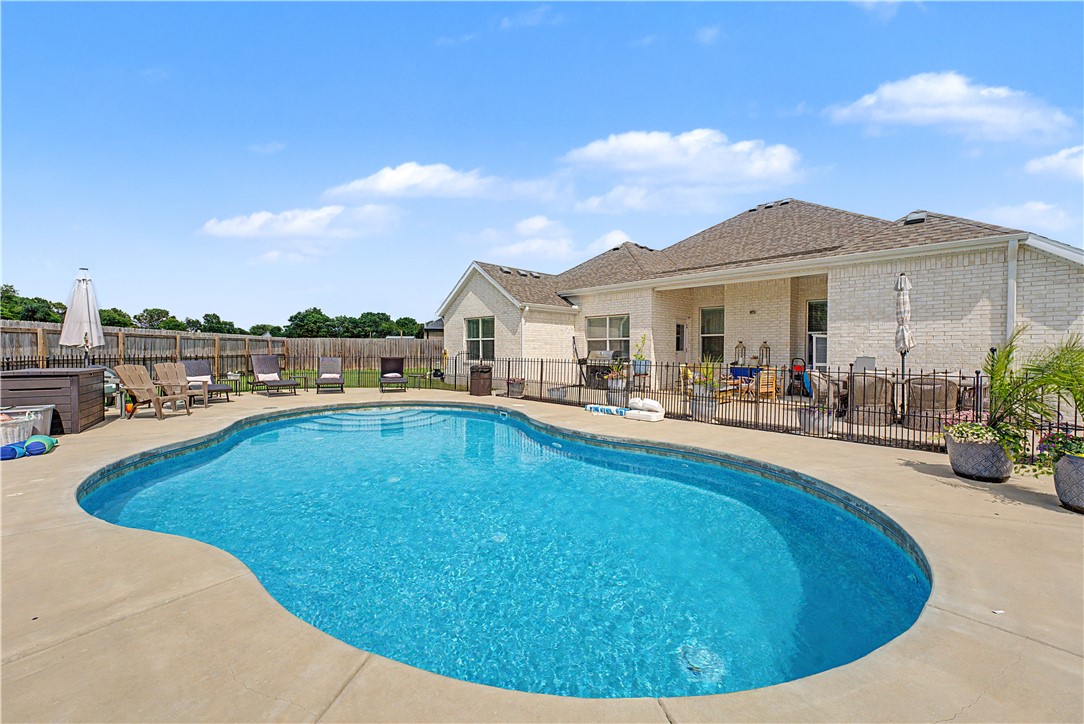 Lovely home with beautiful 20'x32' in-ground salt water pool on an half acre lot. Pool features heat pump with heat or cooling capabilities. The pool has a in-floor cleaning system and enhanced circulation so you won't be spending time cleaning but enjoying your pool all summer! There is also a UV/Ozone system that improves water clarity and destroys harmful contaminates. Patio has been extended and is wired for a hot tub. The home has a open floor plan, 4 bedrooms and 2 bath with LVP throughout most of the home. Refrigerator, washer, and dryer convey.  There is a water softening and purification system. The gas fireplace has a blower to help with heating the home. The garage walls and garage door are insulated to help regulate temperatures and noise. The garage floor is epoxy for stain protection. Great location and great schools!