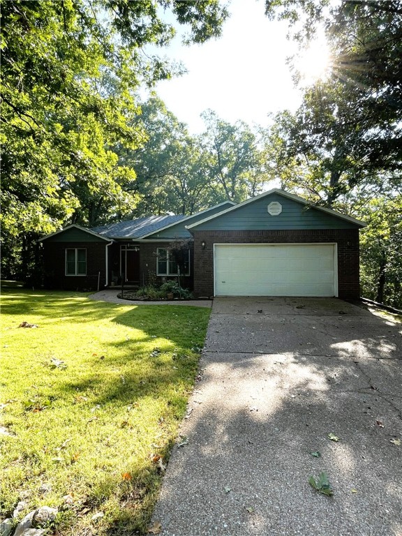 This 3 bedroom 2 bath brick faced home is custom built and one owner that has never had pets or smokers. Large living room with cathedral ceilings opened to formal dining room and nice sized kitchen with beautiful solid oak cabinets. Screened in patio will allow for you to enjoy your cup of joe in any weather while you watch the flora and fauna of the seasons change. Anderson windows are throughout the whole home and allow for light and the views from every angle. Master suite is large in size and includes a double vanity, walk-in closet, walk-in shower and separate water closet. Awesome 288 square foot heated and cooled workshop that has not been counted in the total square footage can be used as workshop or another living space. Bosch DW installed 2020, new roof 2021, HVAC 2015, Hot water tank 2015, microwave 2020. Private and tucked away in the trees with a flat backyard.