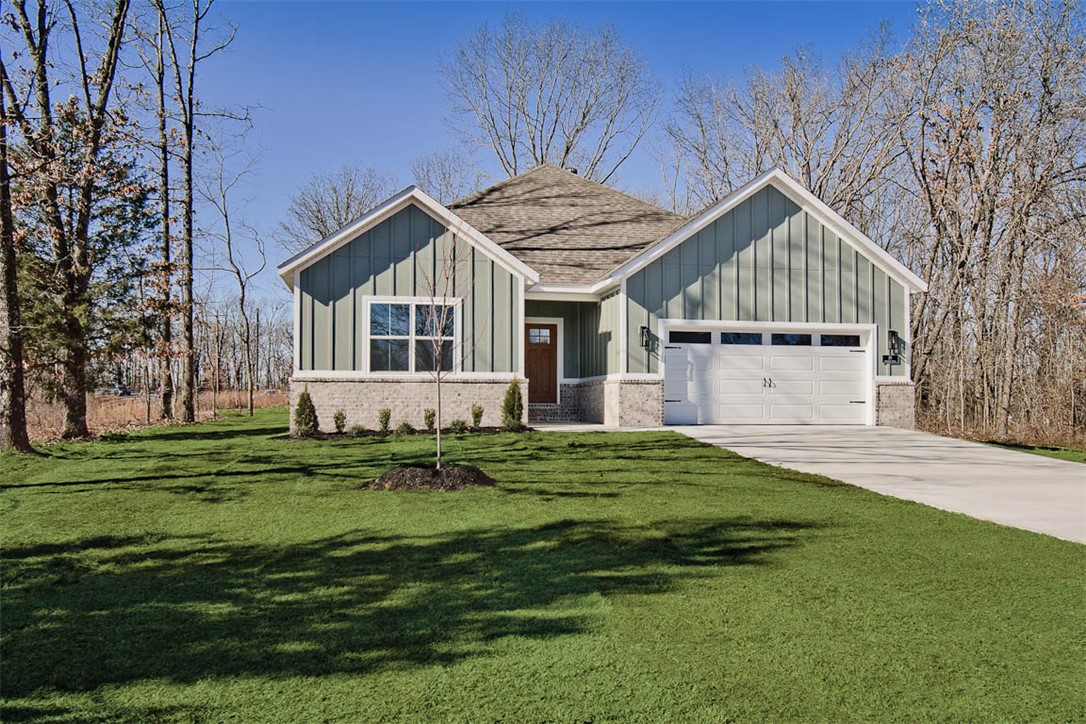 New construction on a .33 acre wooded lot right next to Branchwood Recreation and Nature Trail! Also located within close proximity to Highlands Golf Course, Lake Loch Lomond, and I-49. Step inside to discover an inviting open concept design featuring 10’ ceilings and beautiful floors that enhance the spacious feel of the home. The stylish kitchen is equipped with a gas range, 3 cm quartz countertops, custom cabinets, and a walk-in pantry. Entertain or unwind in the living area, complete with a stunning fireplace, or step out onto the covered patio to enjoy the peaceful surroundings. The primary suite features a massive walk-in tile shower and closet. 2 bedrooms + office. Buyer can also receive $3,500 in closing costs when using the builder's preferred lender!  100% financing (no down payment) is available as this property is eligible for Rural Development Financing.