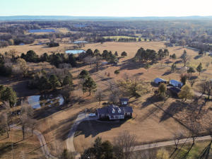 Set in a scenic country setting, this lovely home on 1.5 acres is a perfect choice!  Encompassed within it's spacious 2,020 sf are a large open living area with a cozy country flame fireplace, a lovely sunroom, and a warm and inviting kitchen.  The 18x18 shop with electricity is the ideal place to work on all your projects.  You'll appreciate the peace of mind offered by the storm shelter, two water heaters, and the architectural shingled roof that was just replace in 2019.  For those times when you want to relax, you will love unwinding in the whirlpool tub or sipping coffee in the sunroom!  What a wonderful place to call home!