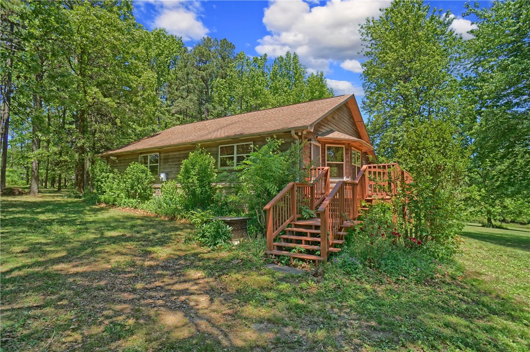 Escape to the peace and privacy of country living with this beautiful 3 bedroom, 3 bathroom home situated on 12 picturesque acres. Offering 1,745 square feet of comfortable living space, this home features an inviting open floor plan perfect for both everyday living and entertaining. The spacious living room centers around a cozy fireplace, creating the perfect gathering spot year-round. The kitchen is filled with warm wood cabinetry, abundant storage, and a large island ideal for cooking, dining, and hosting guests.
Step outside to enjoy the covered front deck overlooking the scenic property complete with a pond, chicken coop, shop building, and storm cellar. Conveniently located just 25 minutes from Lamar and close to the National Forest and the Buffalo River, this property offers endless opportunities for outdoor adventure including hiking, fishing, kayaking, and exploring nature. Whether you're looking for a hobby farm, homestead, weekend getaway, or a property with Airbnb potential, this one has it all!