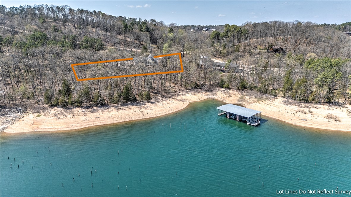 A Rare Offering on Beaver Lake.
Set on nearly an acre with an impressive 341 feet of shoreline, this fully renovated lakefront retreat offers a lifestyle few experience. Complete with TWO boat slips on a co-owned dock, every day begins and ends on the water.
Inside, natural light pours through floor-to-ceiling windows, highlighting vaulted ceilings and a striking fireplace. The open living spaces flow seamlessly to expansive decks with panoramic lake views—perfect for entertaining or unwinding.The kitchen impresses with double ovens, a gas range, and an island prep sink, while the sunroom offers a peaceful spot for morning coffee. The main-level primary suite features a spa-like bath and direct deck access as well as a second bedroom with direct access to sunroom. Downstairs, enjoy a second living area with wet bar, two guest suites with private baths, and additional laundry. Covered patios and easy lake access complete the experience.
Offered fully furnished and turnkey—lake living, elevated. Call today to view