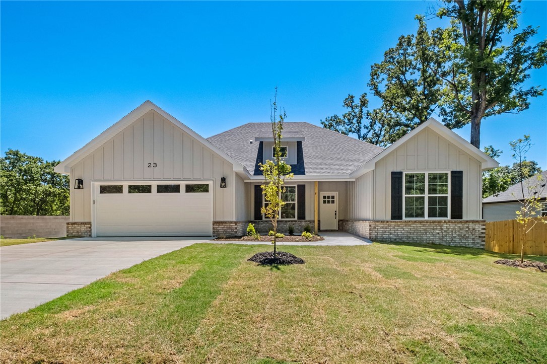 MOVE-IN READY! Stunning new construction home on a large .38 acre wooded lot located next to the Flo Ride Trail Crossing and within close proximity to Lake Ann! Bentonville schools! Step inside to discover a beautifully designed interior with 3 bedrooms + office, a split floor plan, & high-end modern finishes throughout. The spacious living area showcases vaulted ceilings with elegant beams, creating an inviting atmosphere. The kitchen features sleek 3 cm quartz countertops, a gas range, custom cabinets, and stainless-steel appliances. Retreat to the luxurious primary bath, which boasts a huge walk-in closet, a large custom walk-in tile shower, and a soaking tub. 2 covered patios. As an added bonus, receive $3,500 towards buyer's closing costs when working with the builder’s preferred local lender!