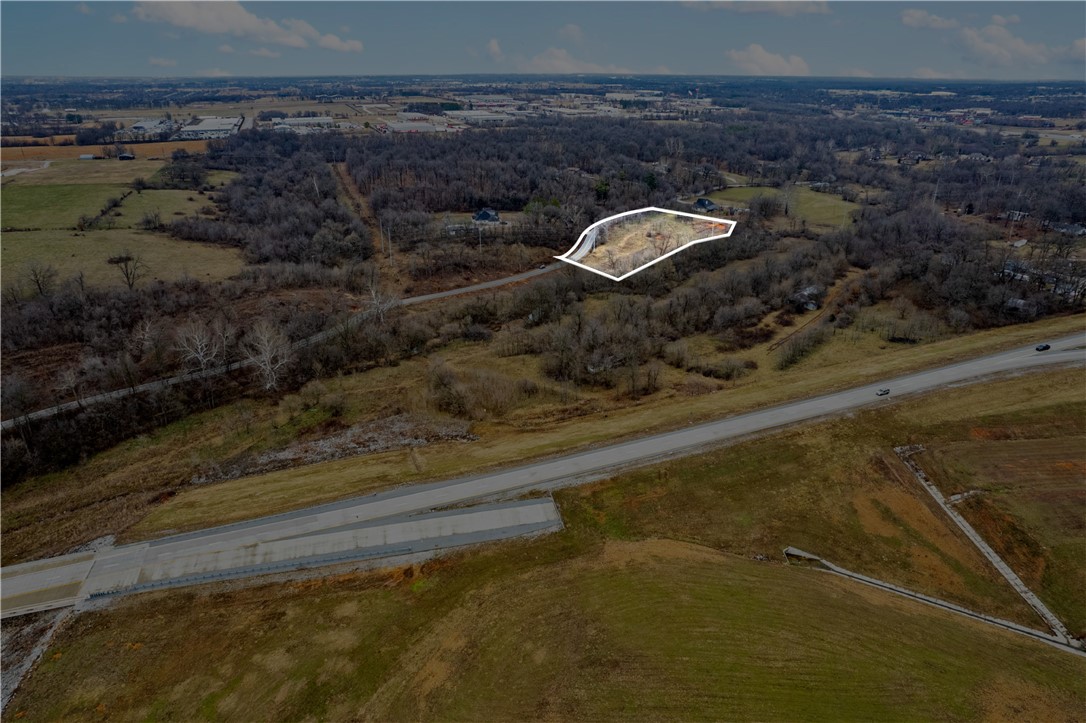 +/- 4.3 acre lot with convenient access to I-49! This property offers water access, and a sewer line that runs right down the middle of puppy creek. Zoned R-2 Immediate Neighborhood, it's an ideal site for residential development or select commercial projects. The lot also backs up to scenic Puppy Creek, adding natural appeal!