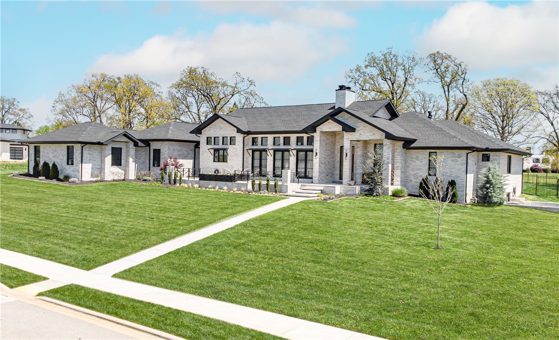 Stunning Rogers home on over 1 acre! This 1 lvl, split floor plan home boasts an open living/dining area with vaulted ceiling and wood beams. Kitchen features a large island, 2 wine fridges, and large built-in fridge. The master suite has an oversized walk in shower, jetted tub, his/hers closets with built-ins, and pool area access. This home is ideal for entertaining as the living room has sliding glass doors open to the back patio and french doors opening to the front patio. The backyard oasis has a heated in-ground pool, fire pit with seating area, and outdoor kitchen complete with dining space. Enjoy sunsets on your front porch while sitting by the 2nd outdoor fire pit. The 4 car garage boasts an electric car plug. Additional amenities include F5 tornado shelter in the office plus additional storage under the home. Located in the exclusive Estates at Southgate, this gated community is only minutes from shopping, dining, and top schools. Make this immaculate home yours!