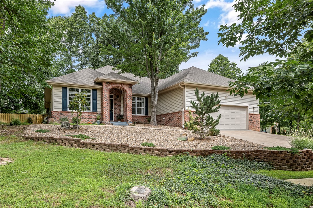 Tucked away on a secluded cul-de-sac, this beautifully renovated Bella Vista cottage on .58 acres feels like a private retreat. The inviting front porch with Italian porcelain tile welcomes you into a home that has been thoughtfully updated from top to bottom. Oversized windows fill the open living and dining areas with natural light, while the sunroom offers the perfect place to unwind. The split-bedroom floor plan features 2 bedrooms, 2 baths, & a bonus room ideal for guests, hobbies, or a home office. The remodeled kitchen showcases 3cm natural quartzite countertops, stunning 3'x10' waterfall island, newer appliances, & modern finishes. An antique oak fireplace surround from a Texas ranch adds timeless character. Major updates include a newer roof, HVAC, flooring, full interior paint, lighting, smart home features, fixtures, landscaping & smart irrigation. Near Branchwood Recreation Center, Loch Lomond, golf courses, & miles of bike trails, this turnkey home is ready to enjoy. 1% preferred lender credit offered!