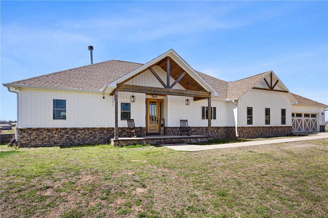 Dreaming of space, privacy, and land you can actually enjoy? This custom-built home on 30.83 acres is what you need! With a mix of open pastures and natural areas, there’s plenty of room to spread out, explore, and create the lifestyle you’ve been imagining. Built in 2021, the home thoughtfully blends modern comfort with a connection to the surrounding land. Inside, the 4-bedroom, 2.5-bath split floor plan is designed for both everyday living and entertaining. Soaring ceilings, an open layout, and quality finishes throughout make the space feel bright and welcoming. Outside, the 40x80 shop is perfect for hobbies, business, or equipment storage, and solar panels provide energy efficiency and long-term savings. Properties that combine a newer custom home, usable acreage, and functional infrastructure are hard to find. Located 15 minutes from Ozark and about 40 minutes from Fort Smith, this property offers the freedom of land ownership without giving up convenience - an ideal setting to live, work, and play.
