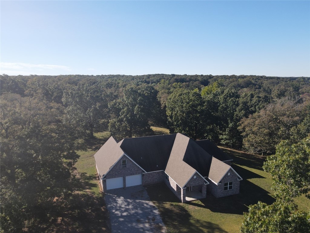 Beautiful setting with live water from multiple streams. So much incredible potential here. 2800+ sq foot home that needs a little exterior cosmetics and landscaping. Garage needs finished out and doors added to the home. Acreage is a mix of open & hard wood with multiple spring fed ponds along with multiple live water streams across the property. Come enjoy your private retreat and surround yourself with lovely views..