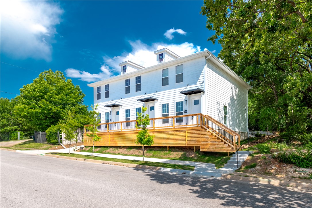 Brand-new triplex in a prime location just down the street from the University of Arkansas campus, Razorback Stadium, Bud Walton Arena, and more! All three units are fully leased, with tenants moving in August 1, 2026, producing first-year annual gross income of $75,600 with strong potential for future rent growth.

Each unit features 2 bedrooms, 2.5 bathrooms, an open-concept layout, and beautiful luxury vinyl plank flooring throughout. The main level offers a spacious living area, dining space, and a well-appointed kitchen with a large island, timeless quartz countertops, stainless steel appliances, and custom-built cabinets extending to the ceiling. Upstairs, both bedrooms offer privacy and comfort, each complete with its own full bathroom.

Located within walking distance to Razorback Stadium, Bud Walton Arena, intramural fields, campus amenities, and more. Refrigerator, washer, and dryer are included in each unit.