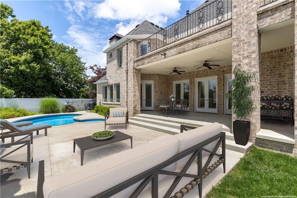 NOW $1,675,000
PINNACLE COUNTRY CLUB.  This timeless Colonial-style residence offers refined living in one of Northwest Arkansas' most sought-after communities. Located within the gated Pinnacle Country Club, the home features 4 spacious bedrooms, each with a private bath, plus 2 half baths. Designed for both everyday comfort and effortless entertaining, the chef's kitchen opens seamlessly to the main living area and includes a gas range, double ovens, large island, walk-in pantry, and abundant cabinetry. Soaring ceilings and multiple living spaces, including a media/game room, provide flexibility throughout. The primary suite offers generous space and a spa-like bath. Outdoors, enjoy a private backyard retreat with an in-ground pool, covered patio, and mature landscaping. A circular drive and 3-car garage complete the curb appeal. Now offered at an exceptional value in Pinnacle Country Club, just minutes from golf, dining, shopping, and entertainment.