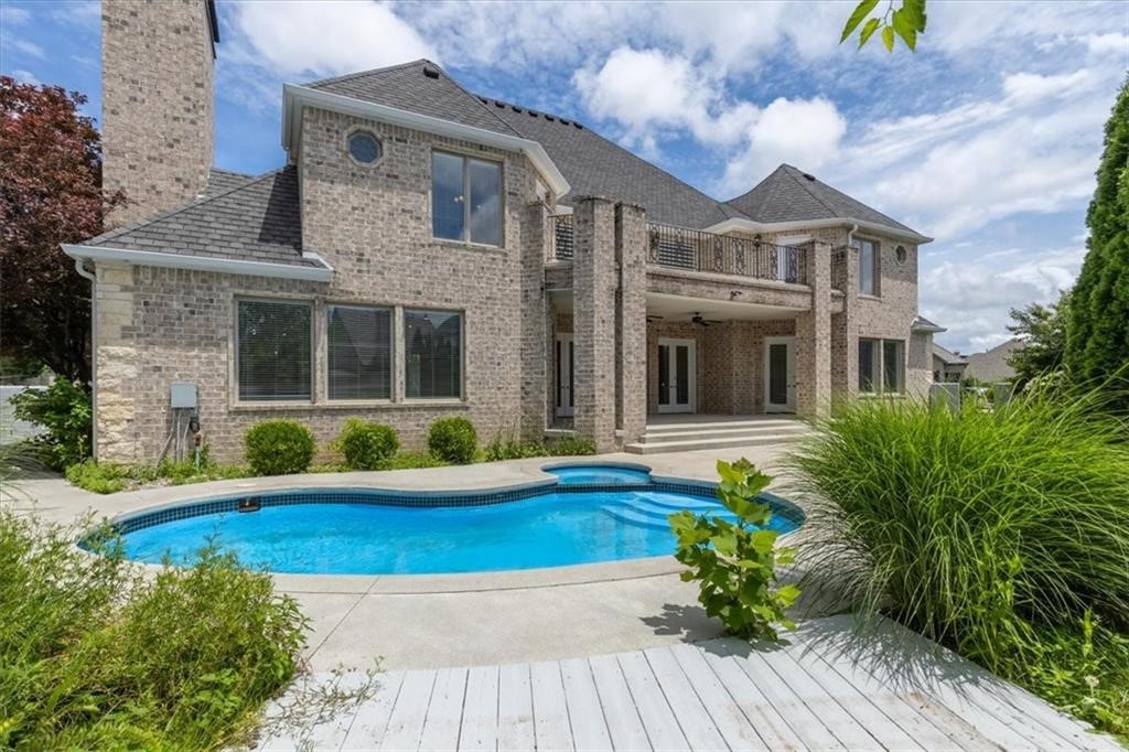 NOW $1,675,000
PINNACLE COUNTRY CLUB.  This timeless Colonial-style residence offers refined living in one of Northwest Arkansas' most sought-after communities. Located within the gated Pinnacle Country Club, the home features 4 spacious bedrooms, each with a private bath, plus 2 half baths. Designed for both everyday comfort and effortless entertaining, the chef's kitchen opens seamlessly to the main living area and includes a gas range, double ovens, large island, walk-in pantry, and abundant cabinetry. Soaring ceilings and multiple living spaces, including a media/game room, provide flexibility throughout. The primary suite offers generous space and a spa-like bath. Outdoors, enjoy a private backyard retreat with an in-ground pool, covered patio, and mature landscaping. A circular drive and 3-car garage complete the curb appeal. Now offered at an exceptional value in Pinnacle Country Club, just minutes from golf, dining, shopping, and entertainment.