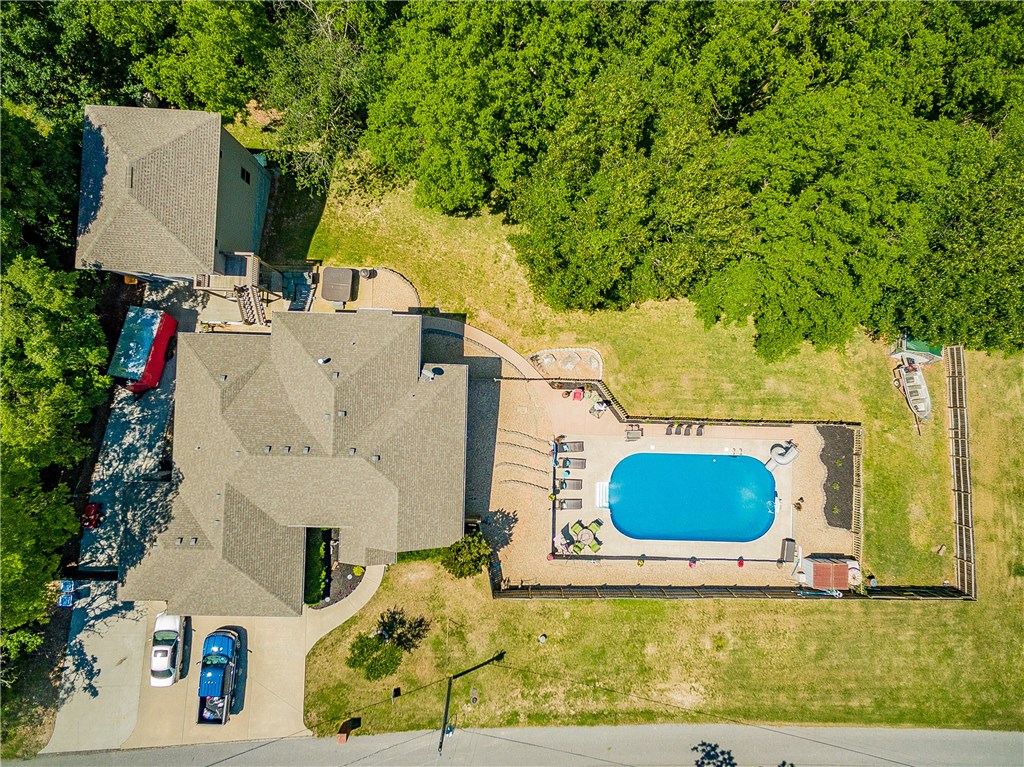Looking for a home with a shop building or pool? Well this one has both!! Large shop space above secondary detached garage and large heated pool. Home recently updated with new flooring, paint and lighting. Eat-in kitchen with granite counters and new appliances. Hall bath and downstairs bath recently remodeled. Home features large entertainment space downstairs for all your family fun! Gather by the pool on a hot summer day or soak in the hot tub to relax. You don't want to miss this one.