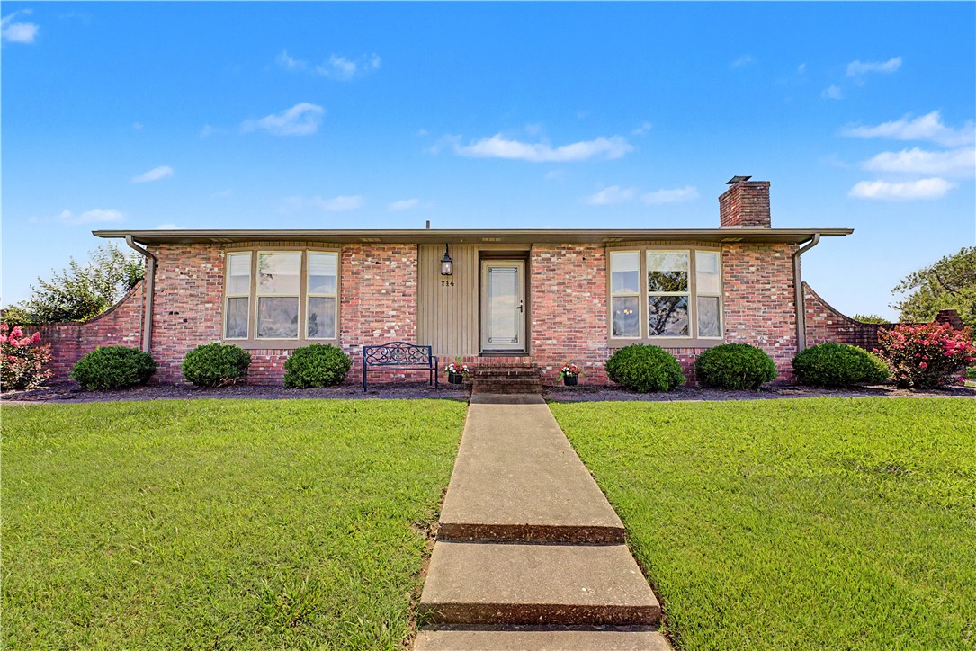 Welcome Home to this move in ready beauty in one of the best locations in NWA! This 3 bed, 2 bath home with a 2nd living area/office space has been meticulously maintained and updated-including solid core doors for extra privacy, new paint and crown molding throughout, built in entertainment shelving (large flat screen tv conveys), LVP flooring, roof in 2024, tankless water heater 2024, Generac 200 amp whole home generator for peace of mind, heat and air relocated to attic, spa like retreat and walk in closet in primary bedroom with bay windows, new painted cabinets in kitchen with bar seating and pantry, and a cozy fireplace that has been converted to electric logs, but lined and gas is available if you choose. Flat, fully fenced, open backyard with covered seating area. Trails just down the road, walk to the Water Park, within minutes of Promenade, The Amp, the future soccer field, and Rogers High School. Get it while it's hot!