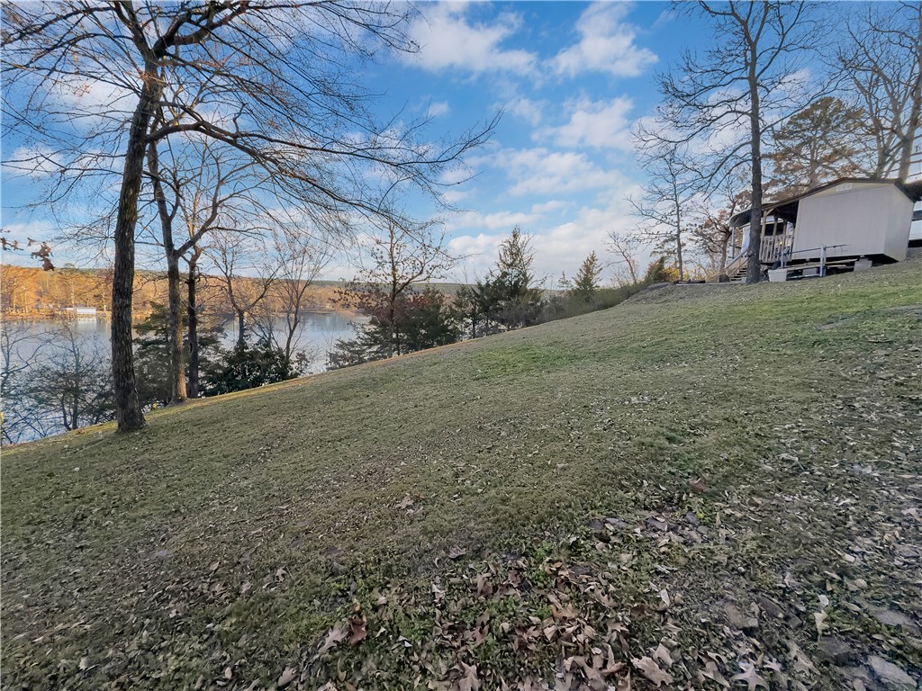 (FIFTH WHEEL CAMPER DOES NOT CONVEY) Water and septic already on site. RV Shed and small carport are both on concrete slabs will convey. One exterior building is for storage and the other is used as a sleeping area with bunk beds.  Boat dock at the lake front with 200 linear platted feet of property.  Property is occupied and must have 24 hour notice to view.  No Trespassing Agent must be present.