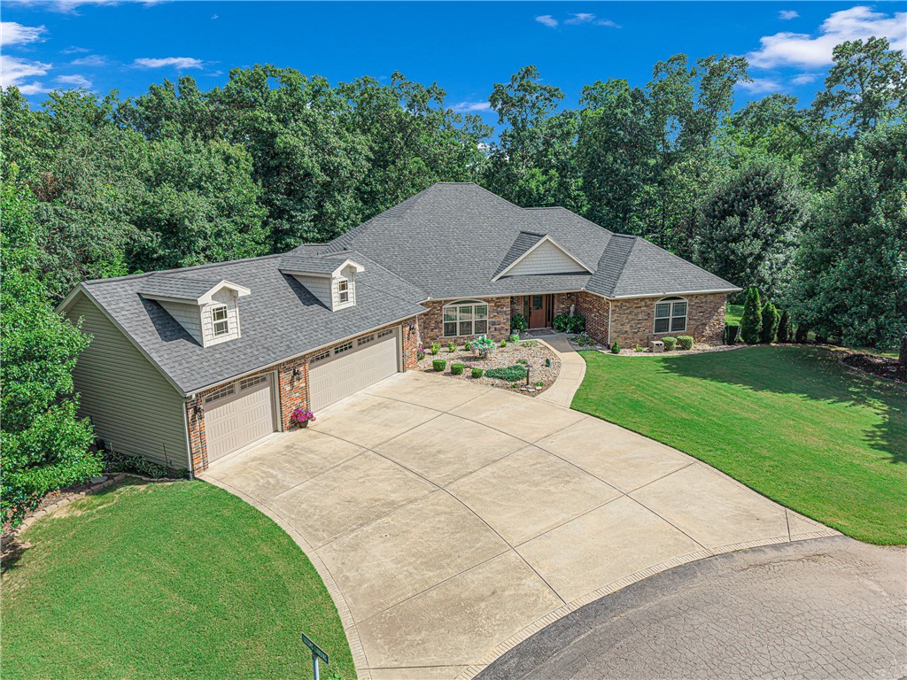 Tucked on nearly an acre in Bella Vista's Mcgrath subdivision, this stunning 2008-built traditional offers 5 generously sized bedrooms, 4 baths, and 4,198 heated sq ft across two levels. The chef's kitchen boasts granite counters, double ovens, a glass cooktop, and an eat-in area. Enjoy two living spaces, each with its own fireplace: a main-level living room and a basement game room with a wet bar. The finished, walk-out basement also includes a theater room and ample storage. Step outside to a covered patio and balcony overlooking the private in-ground salt water pool amid mature trees. Unwind in the sauna or hot tub after a long day. A 3-car garage, quiet cul-de-sac setting, and access to Bella Vista's incredible amenities, including golf, trails, tennis, a boat dock, and clubhouse, complete this exceptional home.