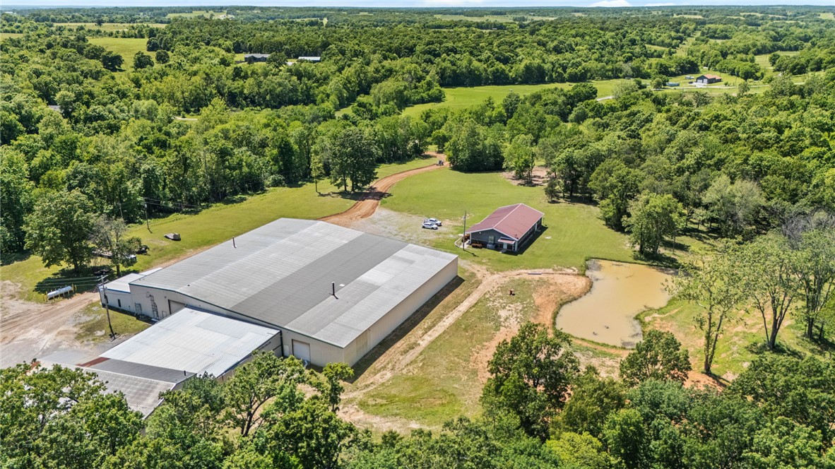 Commercial opportunity on 29.88 acres in the highly desired Honey Creek area. This versatile property offers exceptional potential for commercial, industrial, manufacturing, storage, agricultural, or investment use. Existing improvements include a 3,000 sq ft office building with potential for residential conversion, along with an impressive 31,000 sq ft warehouse/manufacturing facility already in place and ready for operation or expansion. 
The property features a blend of open pasture and partially wooded acreage, offering additional opportunities for recreation, livestock, hunting, trail riding, or future development. A fully stocked pond is perfectly positioned to capture breathtaking views across the scenic landscape. Well and septic are already on site, with rural water available at the street. Rare opportunity to own nearly 30 acres with substantial infrastructure in a prime and growing location just minutes from the city.