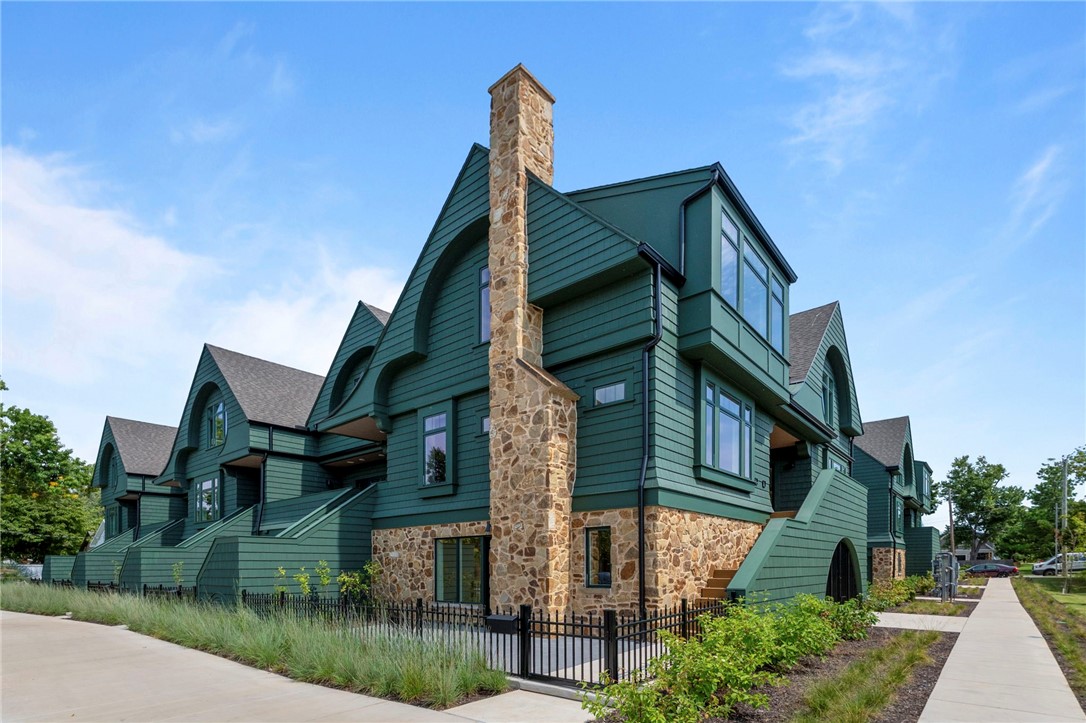 Welcome to Orchard Trailside, Bentonville’s most esteemed luxury townhome community. The property features a fresh and modern reimagining of the Craftsman Revival style. Beautiful 4 bed / 3.5 bath elevator-equipped townhome featuring premium finishes throughout. Enjoy French oak engineered hardwoods, quartz countertops, cast stone fireplace, high-end white oak cabinetry, whole-house water filtration, EV charging, gas range, and smart-home tech including ceiling speakers, Smart Lock entry, and Smart Thermostat. A private mother-in-law suite offers its own entrance, full bath, and beverage station. Oversized two-car garage included. Immediate, out the-door access to the Downtown Trail and the nearby Razorback Greenway. Embrace nature as well as the shared public realm: Residents will find biking, walking, parks, cafés, shopping, the arts, the library, and other desirable lifestyle amenities all within easy reach.