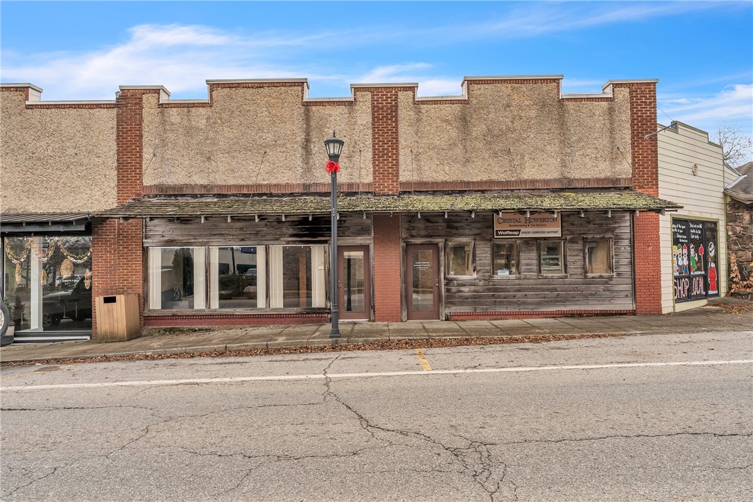 Welcome to a versatile commercial space offering charm, functionality, and exceptional visibility. Featuring gorgeous original woodwork, soaring ceilings, and expansive windows overlooking the vibrant town square, this property provides a bright and inspiring atmosphere for both employees and clients.
The flexible floor plan accommodates multiple office setups, including a spacious main office with a stylish loft—perfect for additional workspace or storage. Beautiful hardwood floors flow throughout, enhancing the warm and professional aesthetic. A convenient kitchenette adds daily practicality, making the space well-suited for a wide range of business uses. Whether you’re seeking a new headquarters, boutique studio, or co-working environment, this property delivers unmatched character and convenience in a prime location.