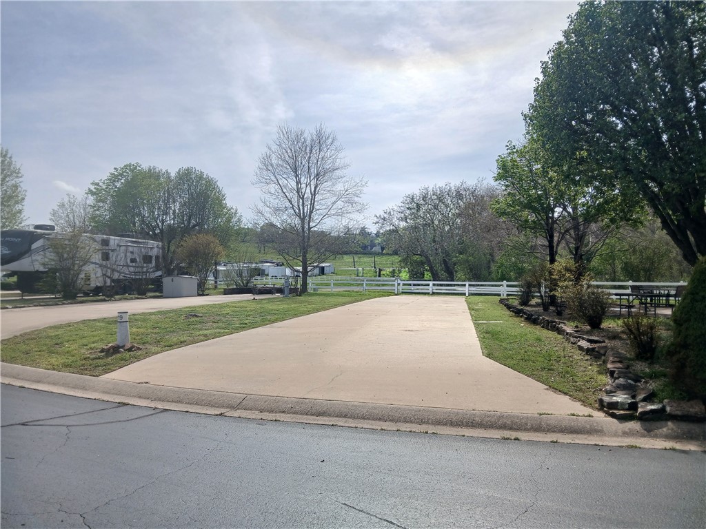 Wrap yourself in the lake breeze with this gorgeously landscaped RV lot on Table Rock Lake. Back in lot is extra wide and offers plenty of parking space and even further opportunities for development should you decide to expand. Close proximity to the bath house, pool and activity center. Full hook ups and only 30 minutes drive from Branson.  Summers were made for the Ozark Mountains.