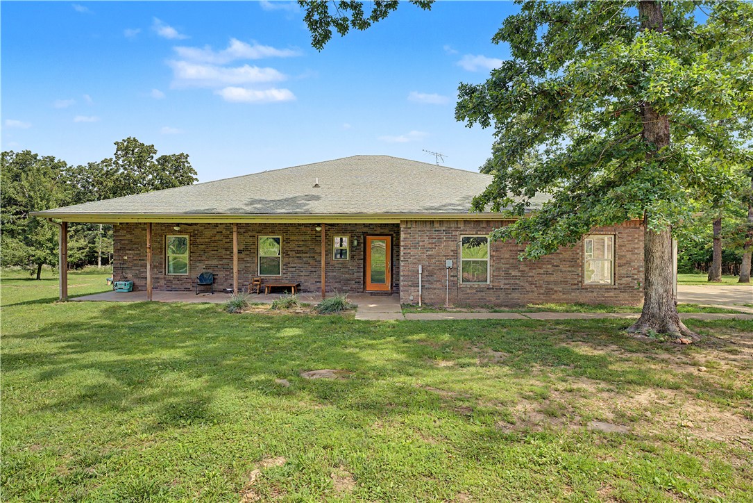 Full brick home on 10 acres less then 5 miles from town! This beautiful property features 3 bedrooms, 2.5 baths and dedicated office that could also serve as a nursery. The spacious great room offers the kitchen featuring quartz countertops , double ovens and ample space for gatherings. Plus, it looks over the dining and living areas featuring the cozy wood burning fireplace with glassed insert and expansive windows that fill the home with light and the nature outdoors. Enjoy over 1200 sq. ft. of covered porches for outdoor living and entertaining, plus an above ground pool to enjoy during the Arkansas days. The acreage has approx 3 open and 7 wooded for use and privacy. Additionally is a shop with electricity. Electrical main is pre-wired for home generator and the home features a Mana block system. All conveniently less than 5 miles from town. Home sits on a private drive 800 ft off the road, appt is needed for access.