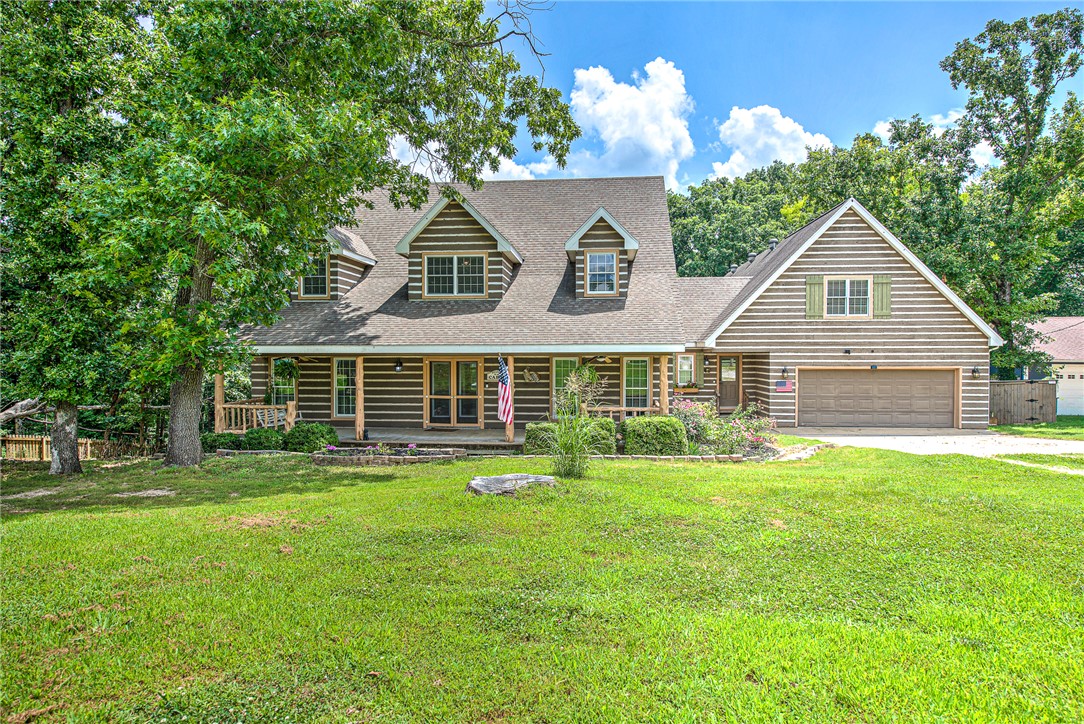 Escape to your own private retreat with in-ground pool, just minutes from Beaver Lake and Horseshoe Bend Marina! Nestled on 2.67 wooded acres, this one-of-a-kind home blends charm, comfort, and function. The inviting living room features soaring ceilings and abundant natural light, creating the perfect gathering space. The kitchen offers a rustic tin ceiling, double ovens, a gas cooktop, ample counter space, and views of the sparkling pool surrounded by lush greenery. With 5 bedrooms and 5 bathrooms and a private "apartment" area, there's room for family and guests. The impressive 43' x 37' attached shop is perfect for hobbies or storage, while the huge floored attic offers endless possibilities. Ideal as a full-time home, lake getaway, or short-term rental investment, this unique property delivers privacy, character, and convenient access to boating, fishing, and everything Beaver Lake has to offer. And if you want to be close to town- only minutes away!