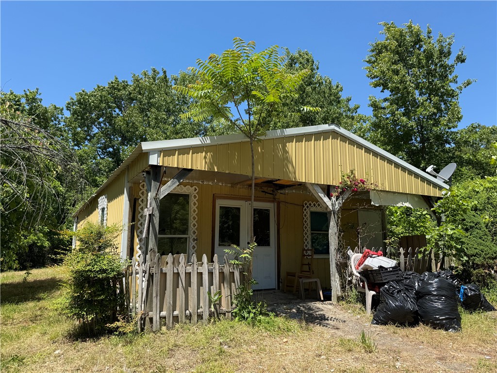 Positioned on a secluded .44-acre lot, this property offers a rare opportunity for an investment project or a private cabin retreat in a prime location, now featuring a freshly graveled driveway for easy access. You are situated just minutes from Bryce's White River Marine and Don Roufa Beaver Lake access ramp, providing immediate entry to the area's best fishing and boating. The structure requires renovation but features a solid footprint for those looking to build equity in a high-demand outdoor corridor. Property sold as is.