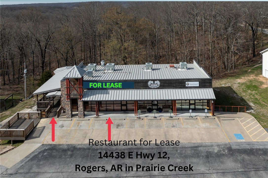 Excellent opportunity to lease a recently renovated restaurant space in the heart of Prairie Creek, Rogers. Situated on Highway 12 E, this highly visible location offers exceptional exposure and access to steady local and visitor traffic. Perfect for a cafe or bar and grill, the space is thoughtfully designed. Interior features include a spacious dining area, an impressive 22-foot wood bar, two renovated restrooms, and a commercial kitchen equipped with a vent hood and grease trap. A new accordian glass door opens to a generous outdoor patio & gazebo for outdoor dining and entertainment. The lower level provides valuable additional space with a roll-up door ideal for a game room with pool tables,shuffleboard,private events, office space,dry storage or operational support. Also an area for outdoor smoker or grill, expanding menu & service possibilities. Located in thriving Prairie Creek area near Beaver Lake, marinas, campgrounds & recreational attractions.