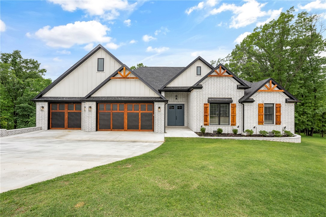 Beautiful 3,756 sq. ft. home in the desirable Top Flight Subdivision featuring 4 bedrooms, 3 full baths, and 1 half bath with a split floor plan, private en suite, and Jack-and-Jill layout. The spacious primary suite includes a large walk-in closet, custom walk-in shower, and exercise room. Designed for comfort and efficiency, the home offers extra insulation, Andersen windows, Tech Shield roof decking, an Carrier Infinity dual-fuel zoned HVAC system, and a H/W recirculation system. The kitchen features upgraded GE Café appliances, custom soft-close cabinetry, under-cabinet lighting, glass-front upper cabinets, a large workstation sink, prep sink in the island, and a wet bar. Enjoy the large covered deck overlooking mature trees, beautiful landscaping, and abundant wildlife. The outdoor kitchen makes entertaining easy and enjoyable. Additional features include a fully sodded yard with irrigation system and EV charging plug in the garage.