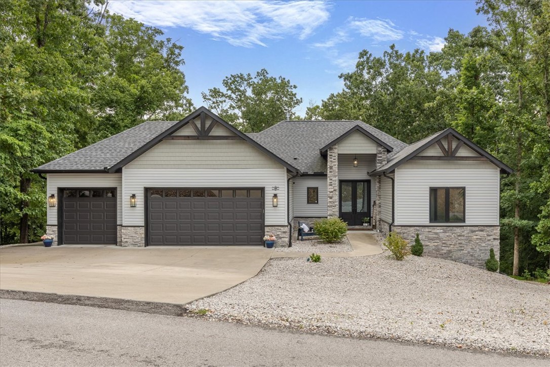 Rare & Exceptional custom home in a premier BV NWA neighborhood! Built with the cutting-edge NuDura ICF series Hercuwall insulated foam and concrete wall system, this residence offers unmatched durability, top-notch structural integrity, and maximum energy efficiency (avg. elec: $100/mo!). Spanning 3,235 sq ft, this amazing home features gorgeous tray ceilings, quartz countertops, butler pantry, a cozy family room fireplace, and a highly functional split-floor plan with a humidity controller next to the programmable thermostat. Enjoy a premium layout boasting 2 separate, complete kitchens—perfect for entertaining or multi-generational living. Downstairs, the extra half bath/storage/mud room could be converted to an additional full bath or ensuite with exterior access. Outside, you'll love the no mnt.  rock yard, the 3-car attached garage with insulated doors. Spend evenings enjoying 2 spacious decks/patios & a beautiful seasonal view of Loch Lomond. Near world-class MTB trails, community pools, golf, and fitness.