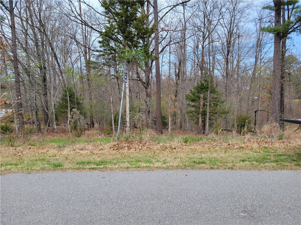 This lot has SEWER ACCESS.  Village Wastewater Company has confirmed that sewer is one lot over from this one and once a signed plot plan is brought in and the tap fee paid, they would be able to connect this lot to sewer.  This lot also backs up to The Back 40 Trail with access to it less than .5 mi. away.  Metfield golf course & country club is only a 4-minute drive away and Lake Rayburn is even closer.  Go check out this lot to visualize your new home there in the midst of all these conveniences.  Bentonville schools!