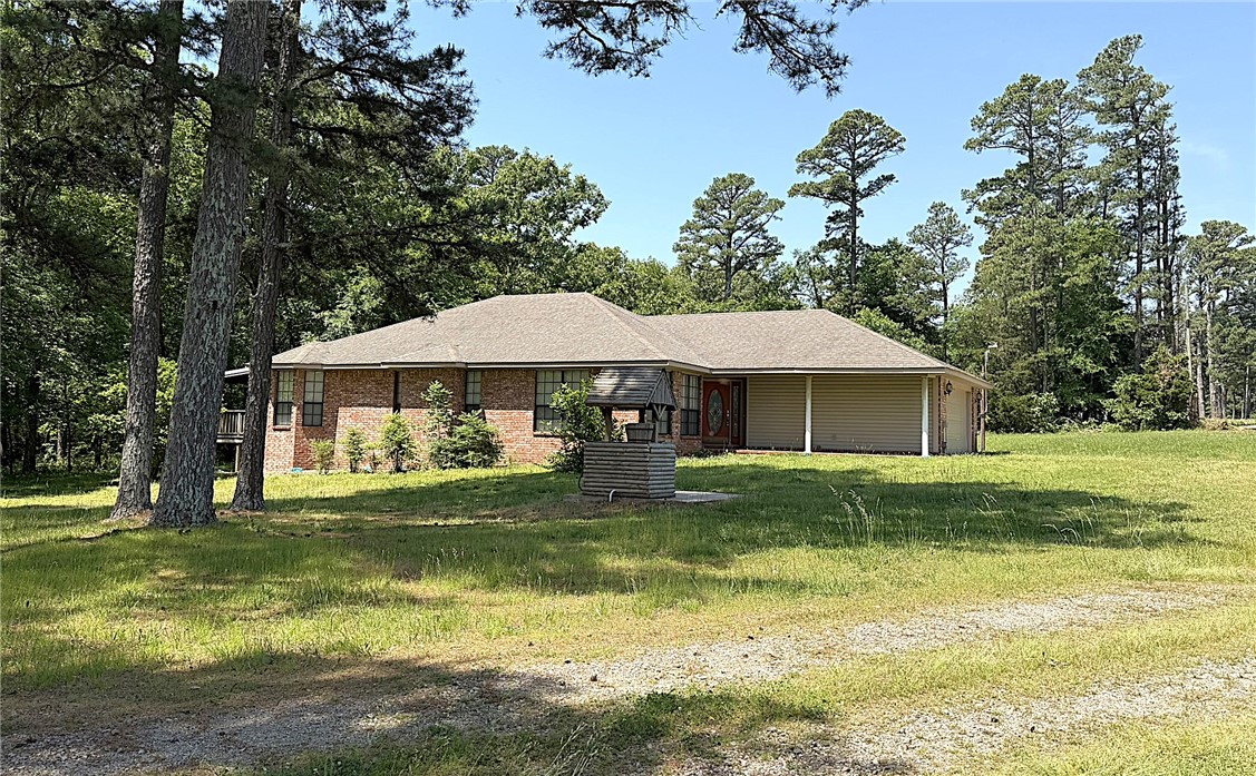 Outdoor enthusiasts take notice! This 1860 sqft brick home sits on just over one acre and adjoins national forest on two sides. Walking distance to Devil's Canyon trailhead and less than a 10 minute drive to Shores Lake! The house is in immaculate condition and features a wood pellet stove, propane log fireplace, and a large kitchen with built in pantry. Master suite has a tile shower and spacious walk-in closet. Fiber internet, rural water (plus a well for watering) and paved highway frontage. The metal barn has four different bays for your storage needs. This property would make a great nightly rental, hunting getaway or just a peaceful place to call home! Most of the furnishings will convey, see agent for details.