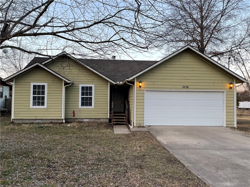 Looking for a cute home or investment property?  Check out this 3 bedroom, 2 bath home with 1126 sq feet.  This spot would make a wonderful home, rental, or even an Air BnB.  It is outside the bustle of the city with the backyard opening to a pasture, but still close enough to everything Fayetteville has to offer.  The tall ceilings in the living room make the space feel large and the wood burning fireplace creates a calming atmosphere on cold nights.  The home has updates including new paint and carpet, garbage disposal, and deck.  The entire house is electric, no gas.  The roof and HVAC are original to the 2008 build date.  The exterior is durable concrete siding rather than vinyl siding.  Only 6 minutes to UofA campus and 4 minutes to i49, this location at this price point is a great opportunity. Book your showing today!
