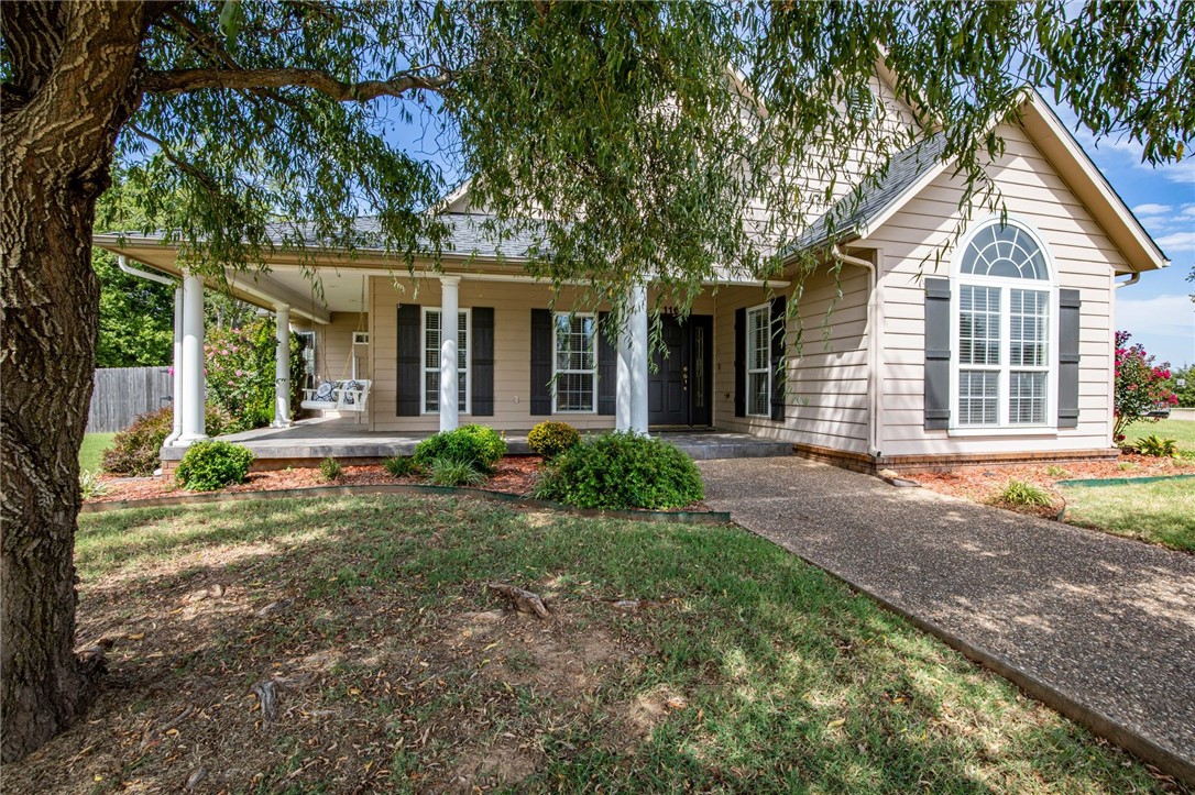 ***$5,000 buyer closing credit & $2,500 preferred lender credit*** Enjoy your mornings on the wrap-around porch or in the spacious backyard of this beautifully landscaped, corner lot, 4BR/3BA home in Farmington. Home features upgrades, plenty of natural lighting, blinds, high ceilings and the sunroom of your dreams with exterior access to a covered back patio. Living room boasts of vaulted ceiling, wood laminate flooring, built-ins, white wooden columns and gas fireplace. Refrigerator conveys! New architectural shingle roof in 2020. Located in North Clubhouse Estates and less than 10 minutes from I-49, restaurants, shopping, business and more.