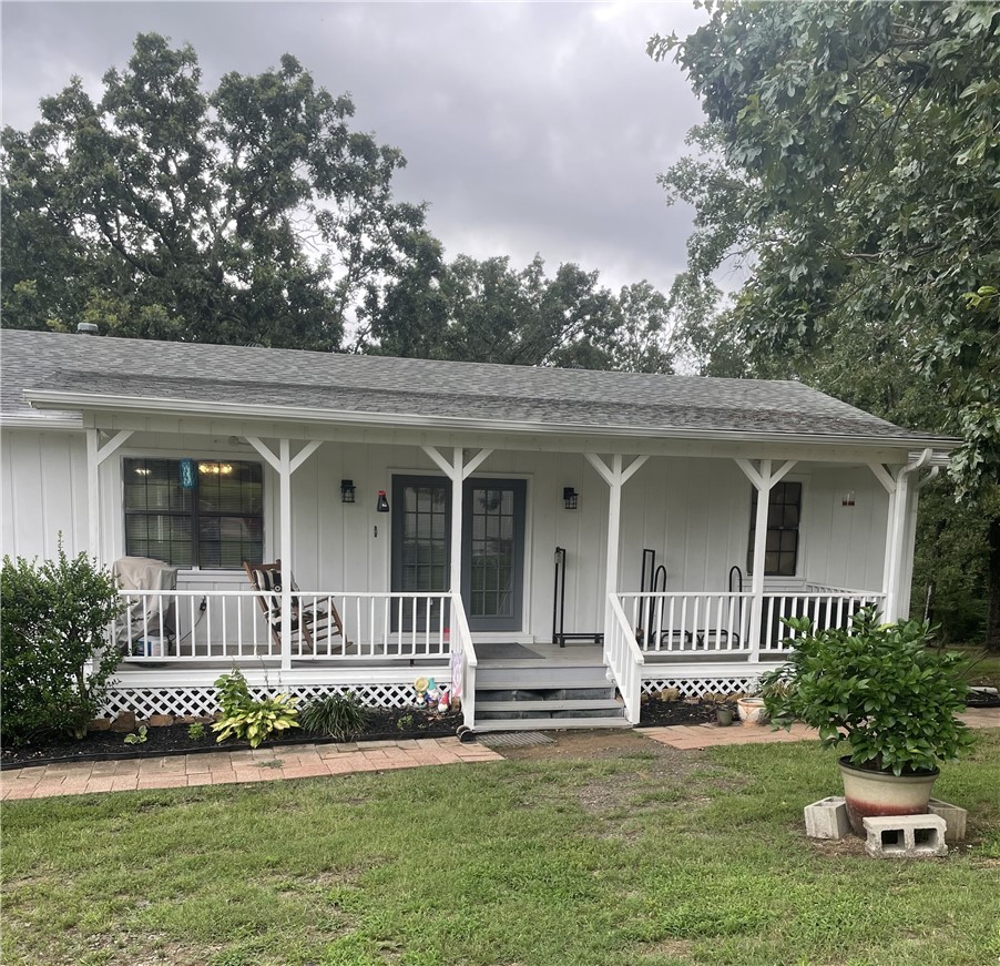 NEW PRICE!!! Move in before summer! Lovely 2320 sq. ft. home on 8.2 acres! Finally live your dream of having your own mini-farm, with animals, fruit trees, gardens! This very desirable location has it all! Large home boasts spacious rooms with tons of light. Primary suite on main level. Recently renovated lower level has a living room, two more bedrooms and a second bath. New roof, water heater and appliances. 2-car detached carport PLUS a 2-car detached garage. Large metal barn wired for electric. Smaller outbuilding with electric & water. Chicken coop/run. Relax on your deck while experiencing the sights and sounds of nature and the views of Mt. Nebo and the River Valley. Gorgeous sunrises every morning and beautiful sunsets every afternoon! Idyllic setting tucked privately off the road, but just minutes from Russellville or Clarksville. This special home blends timeless charm with practical features! Approximately two acres fenced for animals. Water well for gardening and animals, and also a small pond.