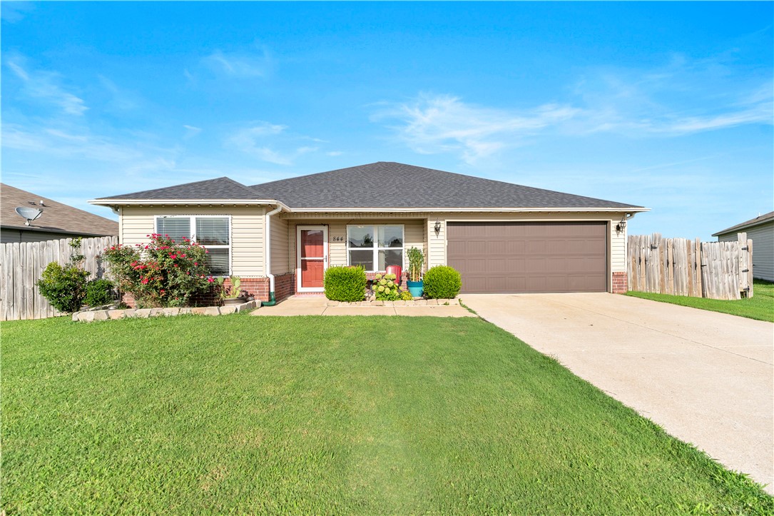 Welcome to 844 NW Evans Cir. in Bentonville! This well-maintained 4-bedroom, 2-bath home offers approximately 1,492 sq. ft. with a desirable split floor plan in the highly sought-after Bentonville School District. The open-concept living area flows into a modern kitchen, creating an inviting space for everyday living and entertaining. Step outside to a spacious raised deck overlooking the fenced backyard, perfect for relaxing, grilling, or hosting family and friends. Conveniently located in an established neighborhood with easy access to schools, shopping, dining, and everything Bentonville has to offer, this home combines comfort, functionality, and a great location. Schedule your showing today!