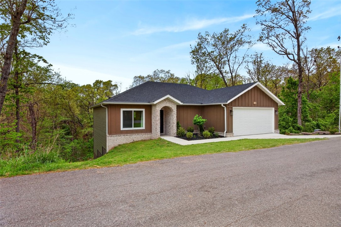 This meticulously maintained home offers the perfect blend of "Like New" with an established yard and professionally landscaped front and maintenance free Leaf Guard gutters. Step inside to discover an open- concept layout with an abundance of natural light, wood flooring, granite countertops, recessed lighting, and an electric fireplace. The spacious primary suite provides a relaxing retreat while the primary bath has a walk in shower and a spacious closet.  Enjoy outdoor living at its best with the Bamboozled bike trail directly behind the home and Lake Avalon is just 2 minutes around the corner offering easy access to biking, hiking, kayaking, swimming or lakeside relaxation. Whether you are looking for a full-time residence or a weekend escape, this home offers the best of Bella Vista living. Don't miss your opportunity to own this incredible property. The TV mounts to remain in living room and primary bedroom. Stainless steel refrigerator and ergonomic swing on deck to convey with an acceptable offer.