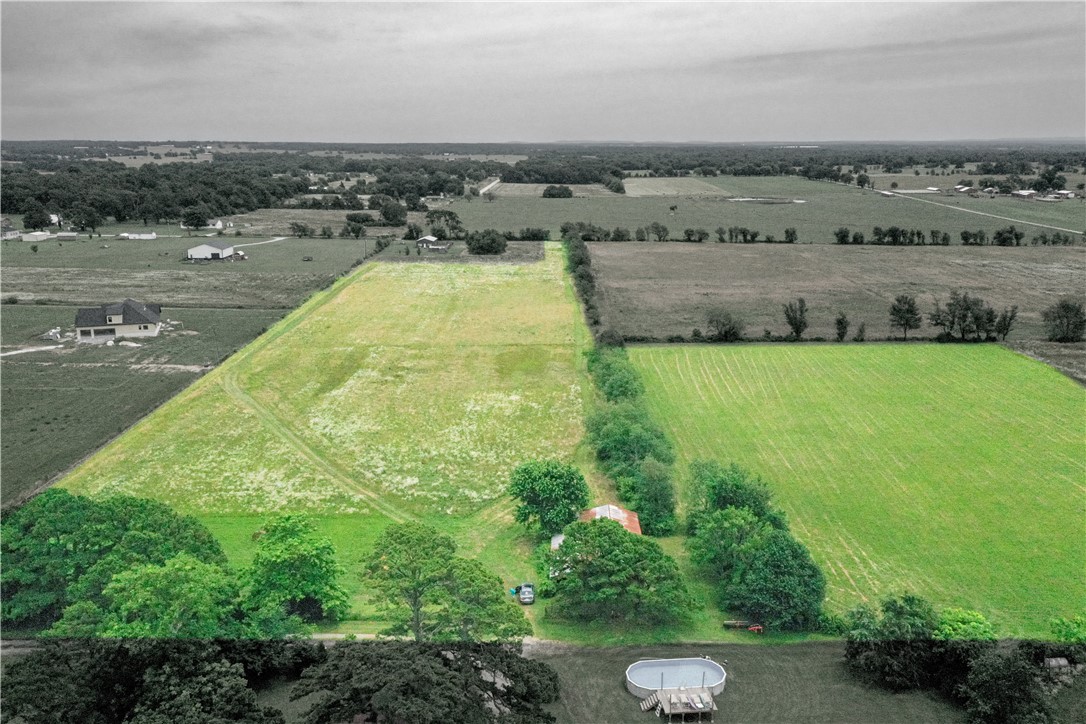 10.42-acre flat land tract in Benton County, Arkansas, between Siloam Springs and Gentry. Tract 2 features a pole barn, level terrain throughout, and a deeded 40-foot access and utility easement to O'Neal Road. The 40-foot easement width accommodates a private drive and utility installation. Level topography maximizes usable acreage and minimizes site prep costs, ideal for a rural homesite, hobby farm, or agricultural operation. Minutes from Siloam Springs shopping, dining, and John Brown University, with quick access to Gentry schools and amenities.