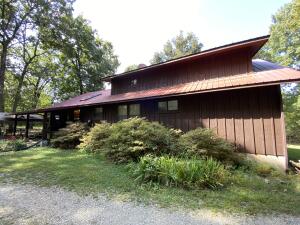 Come and enjoy life in the Ozarks. This wonderful open floor plan with tons of character. Five large bedrooms, large master suite, plus office/man cave or den. Large back deck, detached two car garage and attached workshop with a full bathroom. Outbuildings, carport, lots of storage and plenty of room for your outdoor toys. All positioned on 30 wooded acres offering plenty of wildlife and plenty of privacy, just minutes to Bull Shoals Lake!