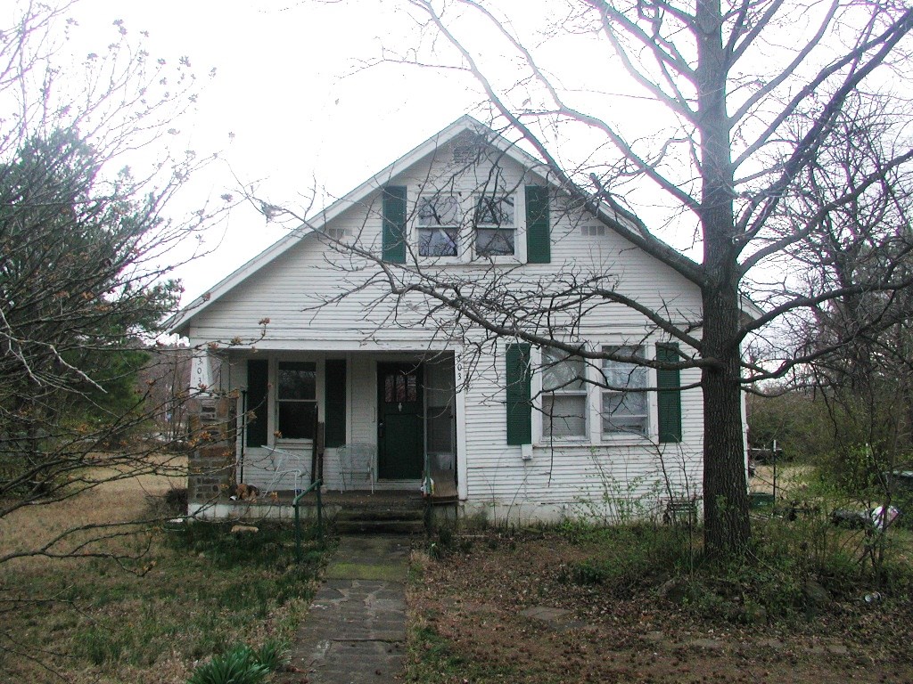 Double lot in central location. House sold as is.