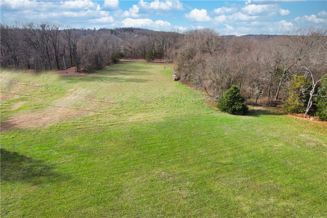This 4.9 +/- acres is the perfect place to build your dream home. Land is primarily flat with multiple building sites for your new home. Underbrush has been cleared so you see topography with a perfect spot if you prefer a cabin in the woods. Plenty of space for a shop building. New, private gravel driveway recently installed for easy access off Ashmore Drive. Paved streets are maintained by city of Garfield. Public water and electric are close with availability in utility easement on east boundary of acreage. Recently surveyed (see attachment) - with stakes and ribbons showing boundaries. Enjoy the slower pace of rural life while being just 15 minutes from Rogers. You are very close to Beaver Lake -in 12 minutes you can be boating, swimming or fishing!