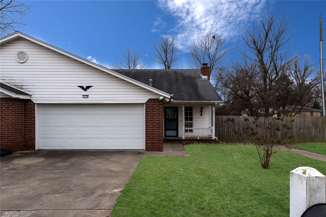 Charming townhome in a great location! Private community on a cul de sac. Close to shopping, dining, and all the best NWA has to offer! This home features a great layout, with a large living room with vaulted ceiling, brick fireplace, and wood laminate flooring. Large windows let in natural light. Built-ins provide extra storage. Spacious kitchen and dining area great for entertaining! Kitchen features plenty of cabinet and counter space. Master bedroom with attached bath. Two additional bedrooms providing extra space. Outside a covered deck and fenced yard create a great outdoor space!