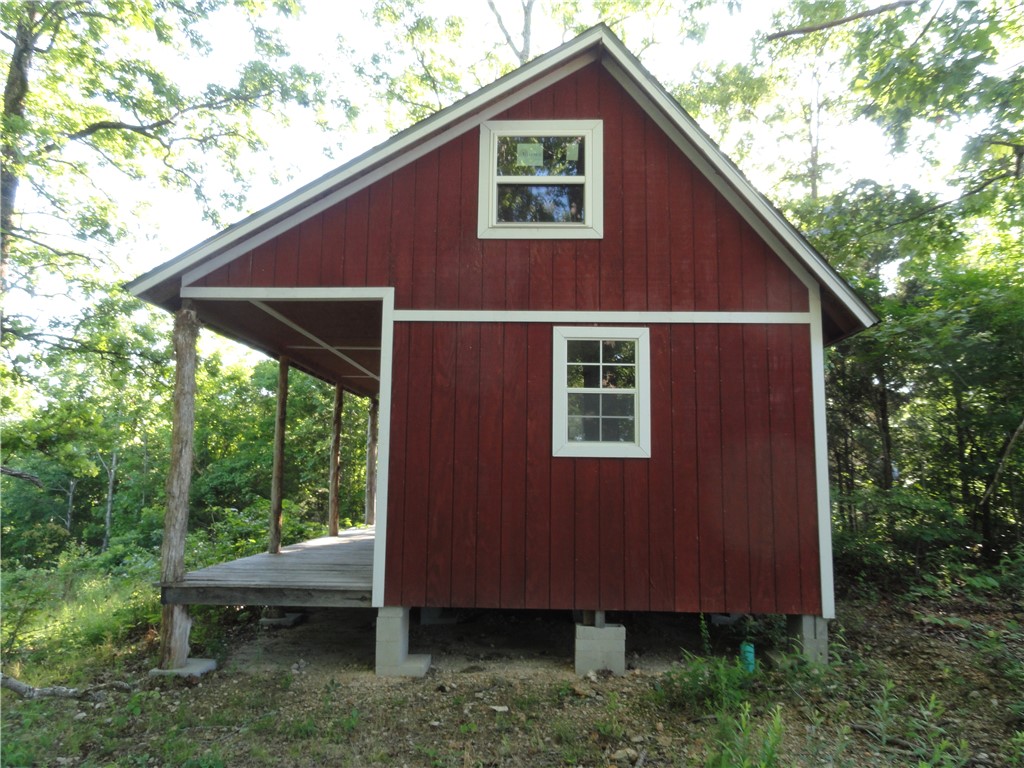 In the hills of North Central Arkansas is where you will find this unfinished cabin waiting for you to personalize it as you like. Water, elec & septic are already in place. Water meter is set & water pipe septic & pipe stubbed up under the cabin. Electricity is terminated in the breaker box inside the cabin with a 200 amp service breaker box. The electric meter is installed and ready for you to finish out the inside wiring to meet your needs. The cabin has a real good view and could be a lot better if you want to take down the trees to open up the view of the distant mountains. The property comes with 13.72 acres & there are other places on the property where you could build another cabin. This property is centrally located in the heart of the Ozark Mountains and close to many vacation destinations and numerous outdoor activities such as floating the Buffalo National River, hiking, hunting, fishing, camping, horseback riding, skiing, fishing & boating on area lakes, visiting Branson MO and Silver Dollar City.
