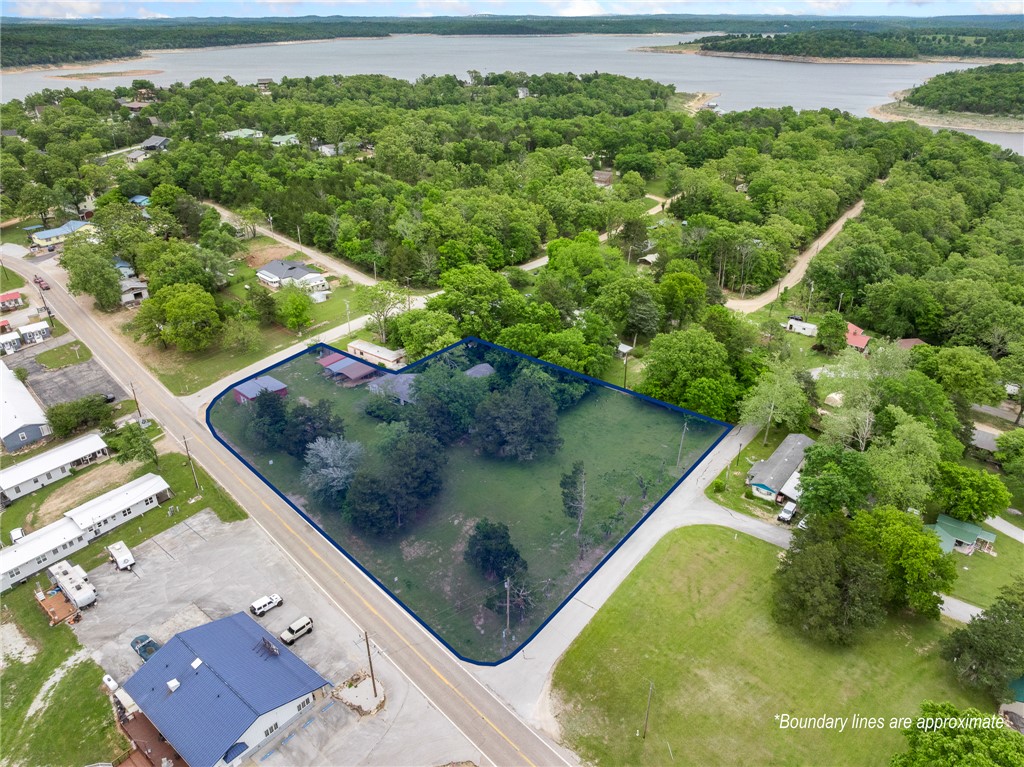 The sky's the limit with this 1.6-acre commercial parcel in Diamond City, Arkansas—a desirable lakeside community on Bull Shoals Lake. Conveniently located just 30 minutes from Harrison, AR, and under 45 minutes to Branson, MO, this property offers excellent visibility and potential. Situated just before the entrance to SugarLoaf Harbor Marina and near Diamond Hills Country Club, the location is ideal for a variety of commercial or investment opportunities. The property includes three structures, one of which is a home ready for renovation, giving you flexibility to reimagine the space to fit your vision. Whether you're looking to develop, invest, or create a unique lakeside business, this property is full of possibilities!
