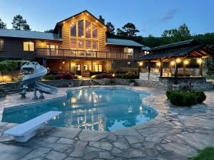 This Log Home Oasis sits on 43.59 ac m/l, Borders national forest, perfect setting,  pond w/tackle shed, 40x60  shop w/heat & air & bath. RV hookup. A detached pavilion w/bath & fireplace. A Smokehouse and bonus well. Inground saltwater pool (fiberoptic lighting) that is self cleaning/heating/cooling AND an outdoor kitchen at poolside. Generac Generator & house filtration system. A water fall that cascades to the pavilion reservoir & back to the waterfall. Outdoor sensor night lighting. Inside is an Immaculate Master suite, chef's kitchen w/butler's pantry. Numerous bonus rooms such as a loft, fitness room, game room, saferoom, office, bedroom w/sitting area and bonus apartment with bed/bath/kitchen. Fiberoptic Internet. This would make a PERFECT Corporate or Personal Retreat.