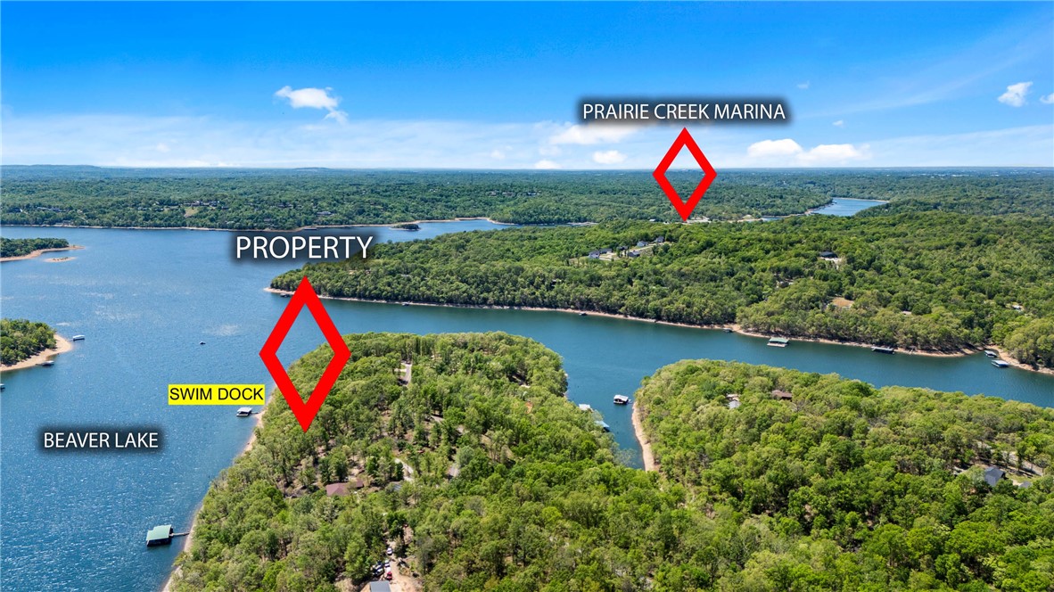 Rare Deep-Water Lake Front Acreage in Coose Hollow on Beaver Lake!
Claim your slice of Northwest Arkansas paradise with ~227’ of Beaver Lake frontage in desirable Coose Hollow (fronting Little Coose Hollow). This premium 2.12-acre lot offers a highly private setting with a gently rolling, sloped terrain, open clearings, and mature hardwoods. Situated in a wide cove with deep water, it includes a private swim dock with its own beach area, all just minutes from Prairie Creek Marina. Enjoy paved road access surrounded by beautiful homes. Recent septic soil test is available with an acceptable offer. High-end custom architectural plans are available for purchase separately. Only 20 minutes to Downtown Rogers and 30 minutes to the Bentonville Square. Buyer due diligence to verify all utilities. Photo boundary lines approximate